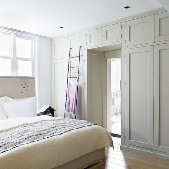 wardrobes taking a whole doorway wall are a sleek and cool storage solution for a bedroom and they brilliantly declutter and save the space