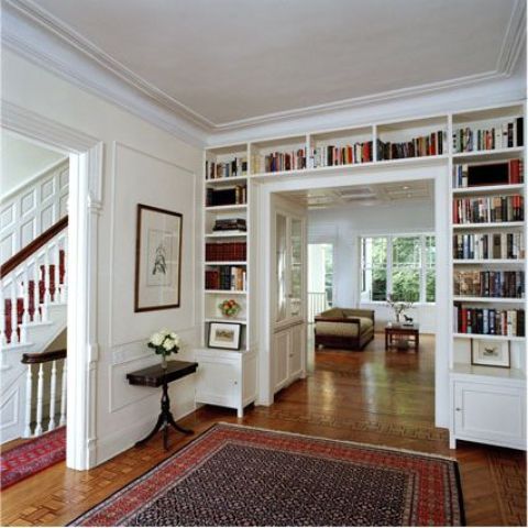 a doorway with built-in shelves is a smart solution to store all the books and give a touch of style to the room at the same time