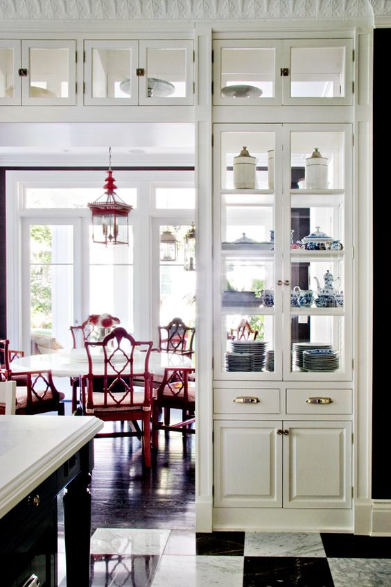 a doorway with a large vintage storage unit, with open storage compartments and drawers is a cool way to store things and separate the kitchen and the dining room