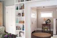 a doorway with built-in shelves is a cool idea to store books and various decor, display them at their best and not to sacrifice any floor space