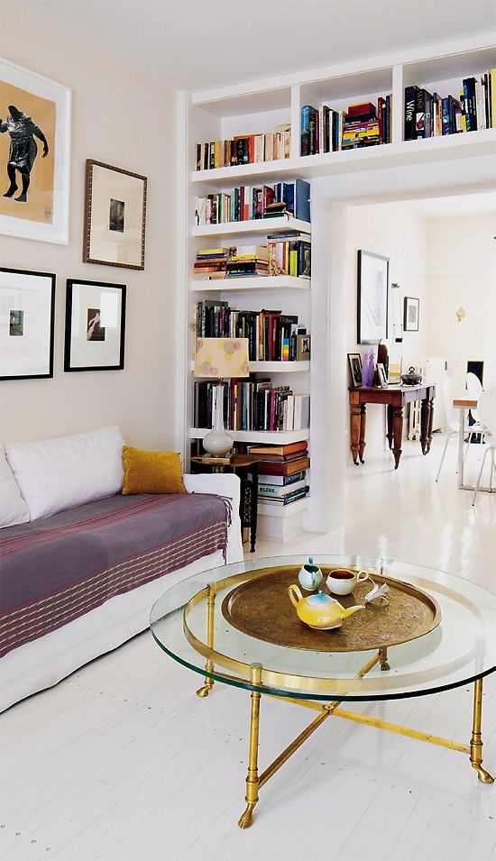 a doorway wall with niche and open shelves is a cool way to store books and to separate the dining and living room more vividly