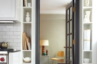 a doorway space taken by open shelves that display pretty tableware and cookware and some cutting boards is a lovely idea for every kitchen or dining room