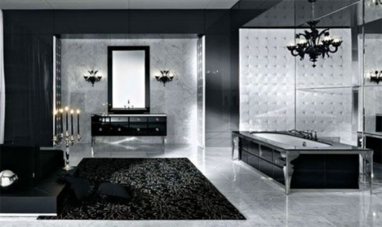 a bold modern black and silver Gothic bathroom with a mirror wall, black furniture, a black rug, a black chandelier and lamps plus black candles