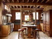 a barn kitchen with stained wood cabinetry, ceiling and wooden beams, concrete sinks and countertops is a very cozy space