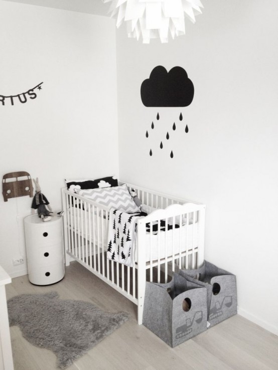 a black and white Nordic kid's room with a white bed and a nightstand, fabric baskets for storage, black and white decor and bedding