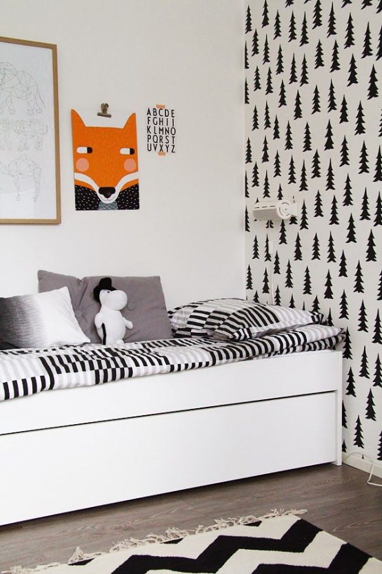 a black and white Nordic kid's room with an accent printed wall, a white bed with monochromatic bedding, a gallery wall with a bright fox art