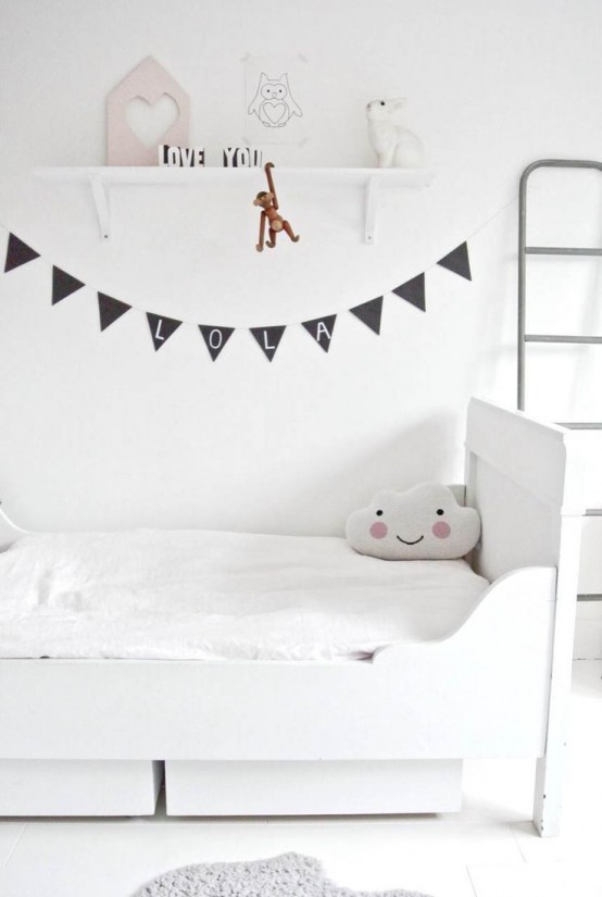 an airy and ethereal Scandinavian kid's room with a white bed and drawers, an open shelf and a ladder and a black banner