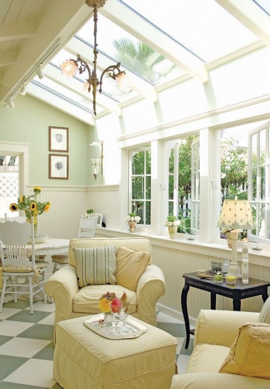 a neutral vintage sunroom with elegant and refined furniture in pastels, pendant lamps, lamps on the tables and much light