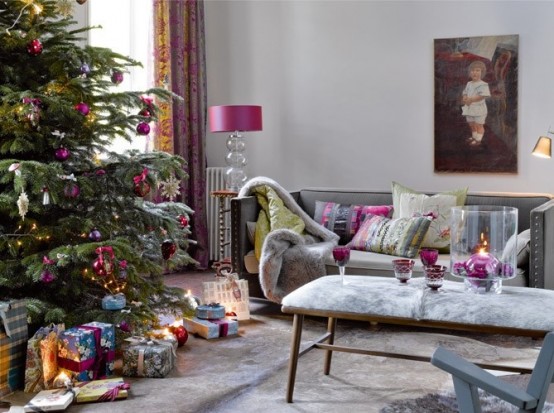 a Christmas tree decorated with fuchsia and purple ornaments, with lights and touches of purple here and there