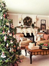 a row of stockings, a fir garland, a lush fir wreath, a Christmas tree with various vintage-inspired ornaments for creating a mood