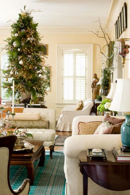 a textural Christmas tree with lights and green and silver ornaments, branches and vintage ornaments for creating a mood