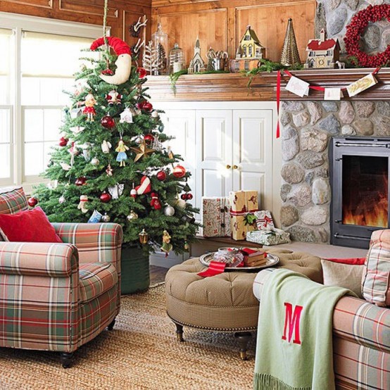a rustic living room with bold Christmas decor - a red pillow, a berry wreath and a Christmas tree with catchy red and white ornaments plus a red garland with bold touches