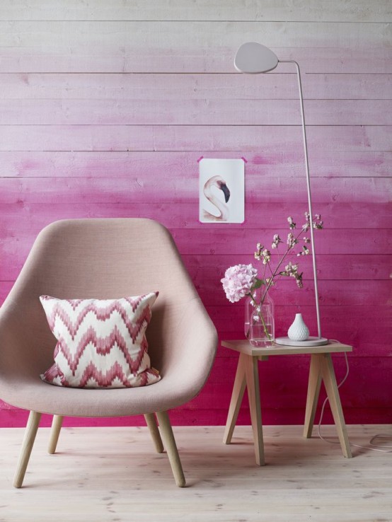 a lovely nook with an ombre fuchsia planked wall, a blush chair with a bold pillow, a side table and a floor lamp is amazing