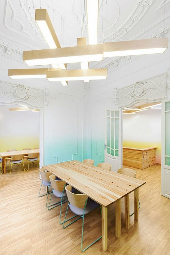 a chic and refined space with a lovely ceiling and walls, an ombre green accent wall, a stained table and plywood chairs and an eye-catchy sculptural pendant lamp