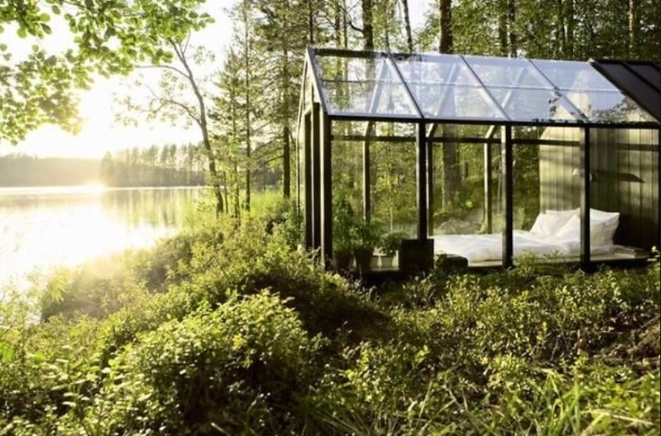 a clear glasshouse on the lakeshore, with a single bed inside is a gorgeous place to go to sleep and to enjoy first sun rays