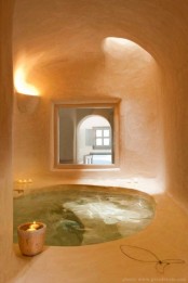 a gorgeous sunken bathtub or even a plunging pool seems to be cut out right in here and lit with a skylight