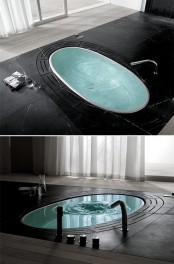a sunken bathtub integrated into black stone contrasts it very much and stands out thanks to that