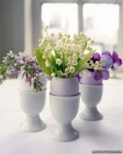 pastel eggs in holders with little spring flower arrangements are amazing for an Easter party