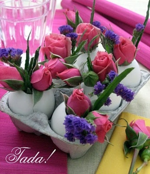 a carton with eggs and purple and pink blooms is an easy Easter centerpiece idea
