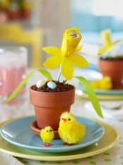 a pot with chocolate pudding, candy eggs and a yellow paper bloom plus chicks for Easter