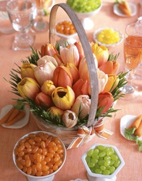 a basket with orange, rust, yellow tulips and grass as a cute Easter centerpiece