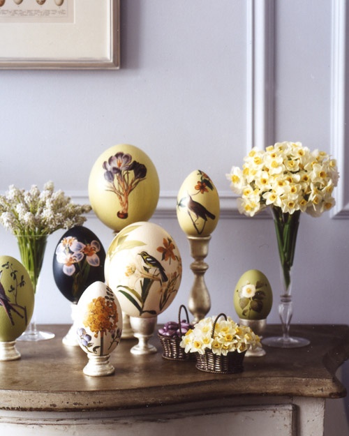 daffodils and hyacinths in vases and painted eggs in holders for Easter