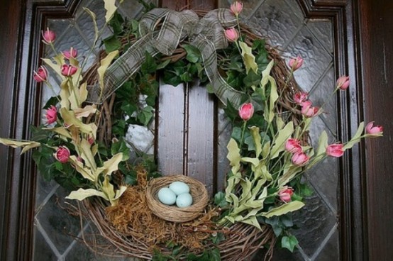 a bright spring wreath with a ribbon bow and a faux nest with eggs