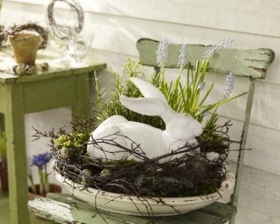 a bowl with some vine, greenery and a bunny on top for vintage Easter decor