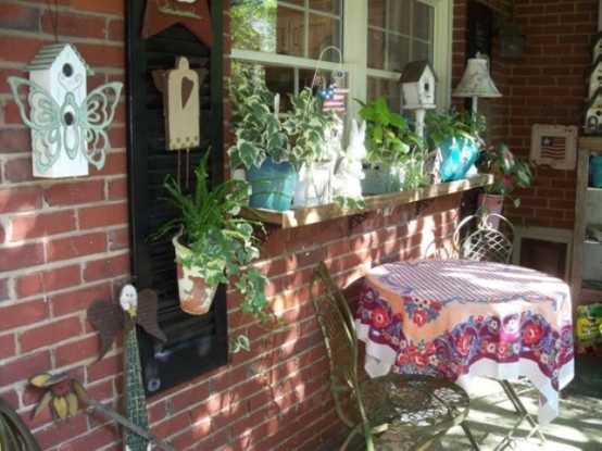 a window box with potted greeneyr, bunnies, bird houses, lamps and butterflies for Easter