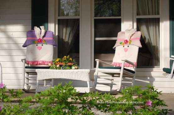 two rocking chairs with bunny covers and a bright floral arrangement for Easter