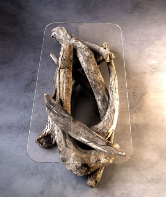 a refined and ultra-modern coffee table of driftwood and a clear tabletop over it is a chic and bold solution to rock
