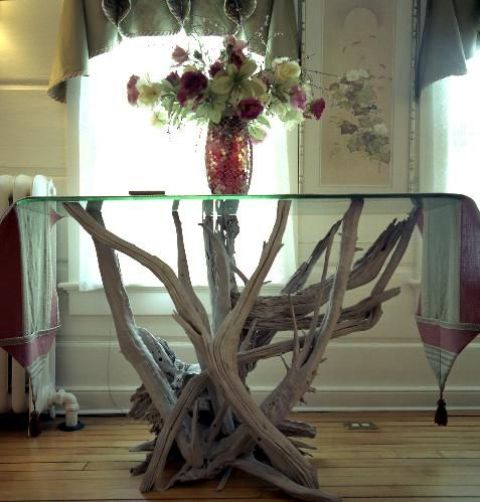 a pretty table of a driftwood base and a glass tabletop is a lovely idea for many spaces, in many styles and you can DIY it