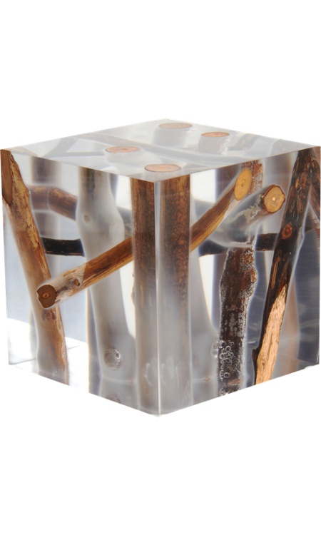 a clear resin side table with lots of branches and driftwood inside is a lovely idea to add a natural feel to the space