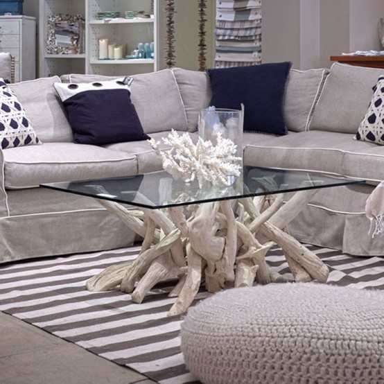 a lovely driftwood coffee table of whitewashed driftwood with a glass tabletop is a stylish idea for any sea-inspired interior