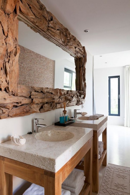 an oversized mirror in a driftwood frame will bring a beachy or coastal feel to the bathroom and it looks amazing