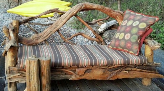 a pretty eco-friendly outdoor bench composed of driftwood with ligth staind, of a striped cushion and a prette pillow is a bold idea for outdoors