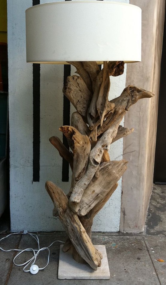 a large floor lamp made of driftwood and a white round lampshade is a cool idea for a modern coastal or beach interior