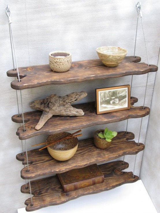 a hanging shelving unit of shelves made of driftwood and stained dark is a creative idea for a beachy or coastal interior