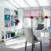 a feminine home office in white, with colorful accents – striped curtains, table lamps and blue files is a welcoming space