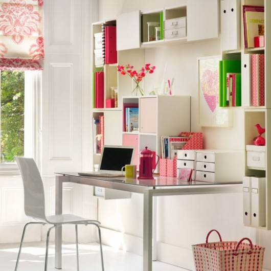 a colorful feminine home office in neutrals but with bright red, pink and green accents that make it cheerful and fun