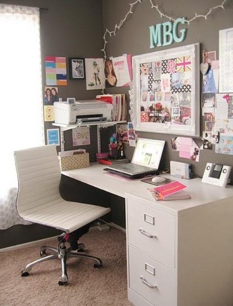 a neutral grey home office with a white desk and chair, with a memo board with bright elements is lively and welcoming