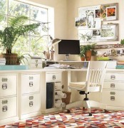 a comfortable home office done in neutrals, with cool storage furniture, a bright rug and some potted greenery