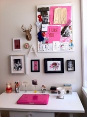 a neutral girlish home office accented with a large gallery wall with hot pink touches and a hot pink laptop
