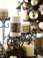 exquisite vintage Christmas decor – black candelabras, gold ornaments, black beads and candles wrapped with chic pieces and tassels is lovely