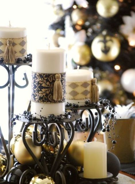 exquisite vintage Christmas decor - black candelabras, gold ornaments, black beads and candles wrapped with chic pieces and tassels is lovely