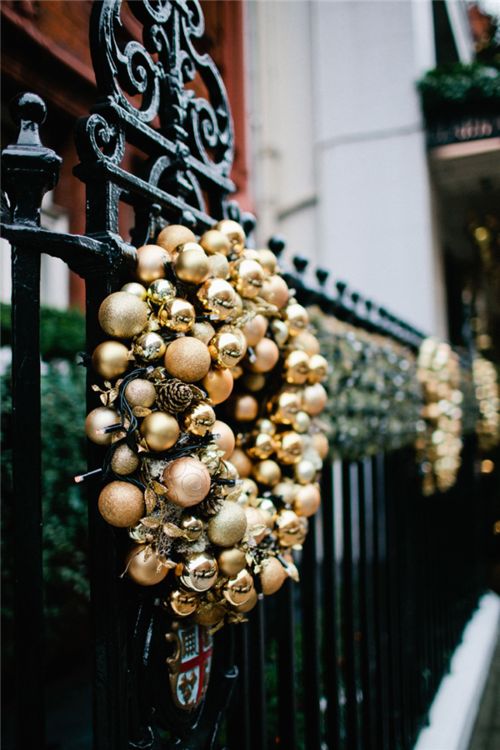 make gold ornament and pinecone Christmas wreaths and hang them outside to add a refined holiday touch to your outdoor spaces