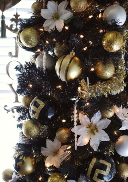 gorgeous glam blakc, gold glitter and white Christmas tree decor with lights, fabric blooms, beads and icicles is a lovely and bold idea