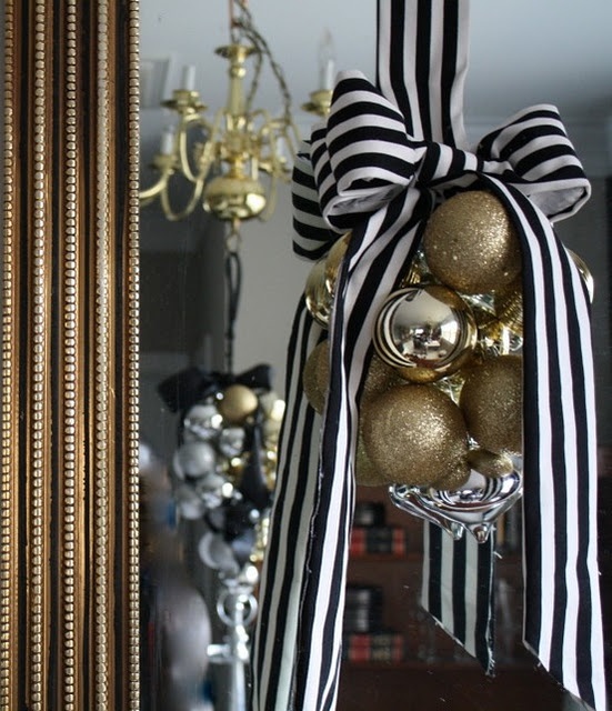 a lovely glam Christmas decoration of gold and gold glitter ornaments and with a striped bow is a cool idea for Christmas and NYE