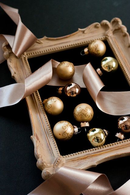 an elegant vintage frame with gold and copper glossy and patterned ornaments and a ribbon is lovely and veey exquisite holiday decor