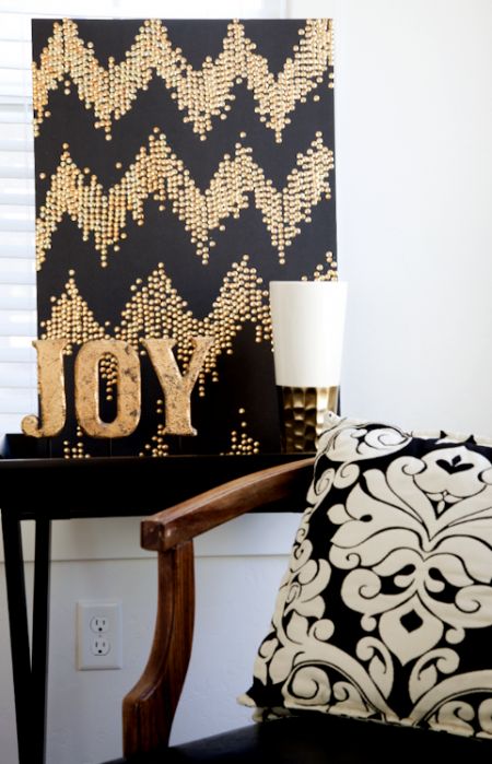 a black and gold Christmas sign with a chevron pattern and gold letters is a lovely and chic idea to rock on holidays
